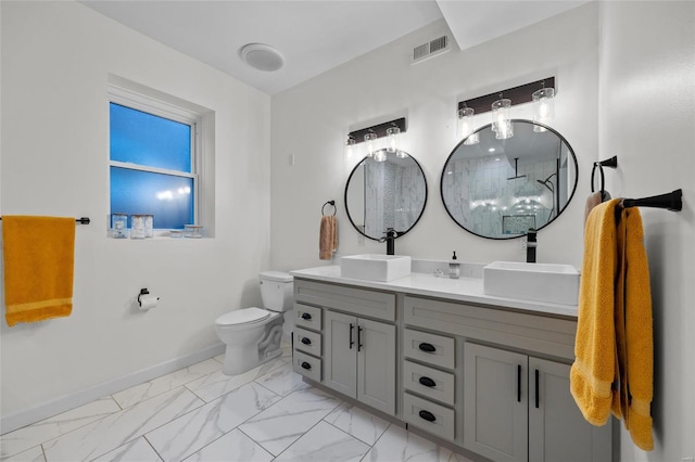 5818 Westminster Pl, Saint Louis, MO 63112 - bathroom featuring marble look tiles, baseboards, toilet, double vanity, and a shower