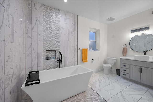 5818 Westminster Pl, Saint Louis, MO 63112 - bathroom with a soaking tub, vanity, marble finish floors, toilet, and baseboards