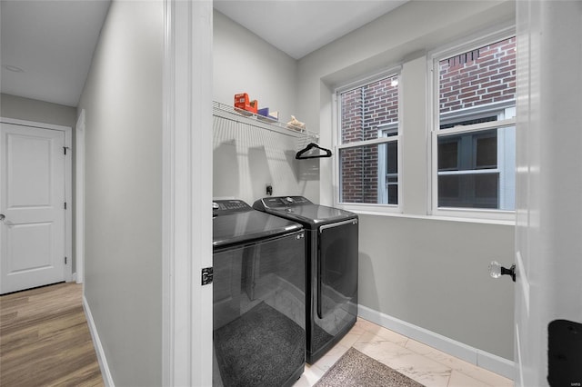 5818 Westminster Pl, Saint Louis, MO 63112 - clothes washing area featuring washing machine and clothes dryer, baseboards, and marble look tiles