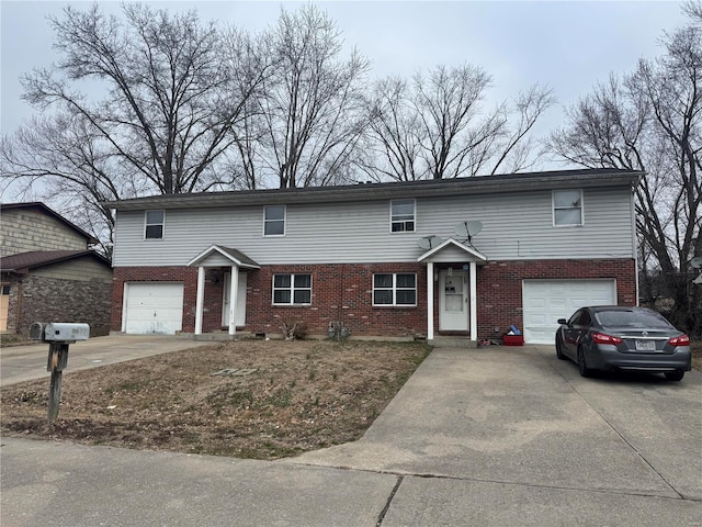 1022 Village Ln, Cape Girardeau, MO 63701 - townhome / multi-family property with a garage, concrete driveway, and brick siding