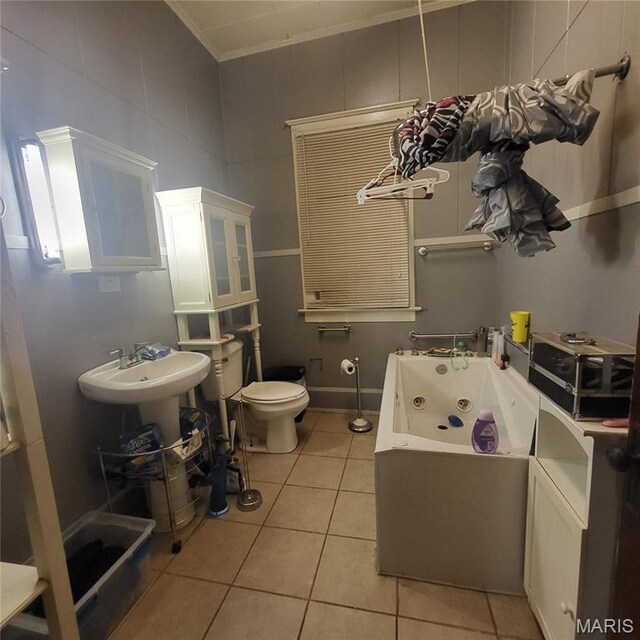 808 Walnut St, Doniphan, MO 63935 - bathroom with tile patterned floors, toilet, a whirlpool tub, and ornamental molding
