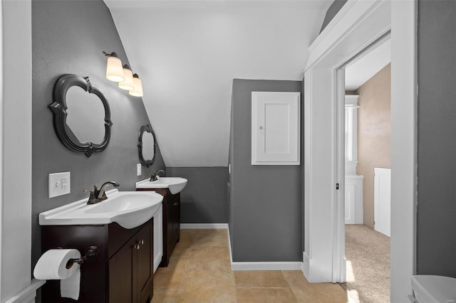 211 E Alton St, Marine, IL 62061 - bathroom featuring lofted ceiling, two vanities, tile patterned flooring, and baseboards