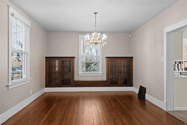 211 E Alton St, Marine, IL 62061 - unfurnished dining area featuring hardwood / wood-style floors, a chandelier, and baseboards