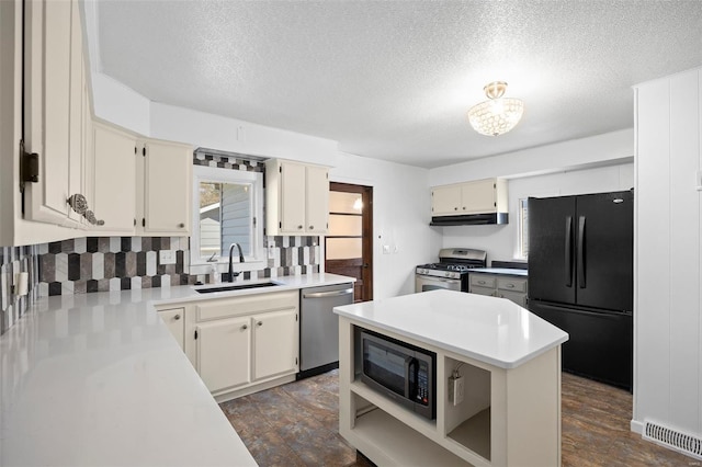 211 E Alton St, Marine, IL 62061 - kitchen featuring black appliances, a sink, under cabinet range hood, backsplash, and light countertops