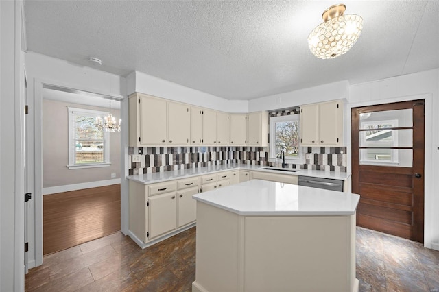211 E Alton St, Marine, IL 62061 - kitchen with a chandelier, a sink, backsplash, light countertops, and a textured ceiling