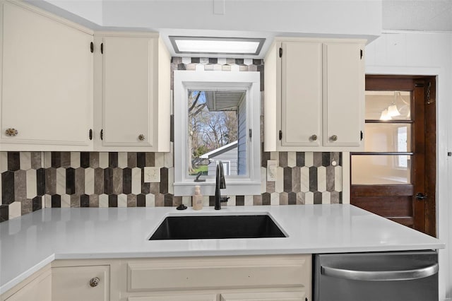 211 E Alton St, Marine, IL 62061 - kitchen featuring stainless steel dishwasher, a sink, light countertops, and tasteful backsplash