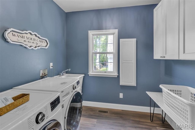 3560 Saint Albans Rd, Saint Albans, MO 63073 - washroom with cabinet space, washing machine and clothes dryer, dark wood finished floors, and baseboards