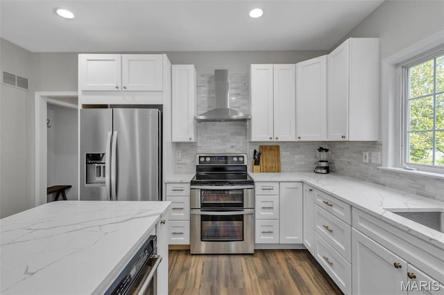 3560 Saint Albans Rd, Saint Albans, MO 63073 - kitchen featuring wall chimney exhaust hood, appliances with stainless steel finishes, white cabinets, backsplash, and recessed lighting
