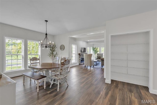 3560 Saint Albans Rd, Saint Albans, MO 63073 - dining room with dark wood-style floors, healthy amount of natural light, a chandelier, and baseboards