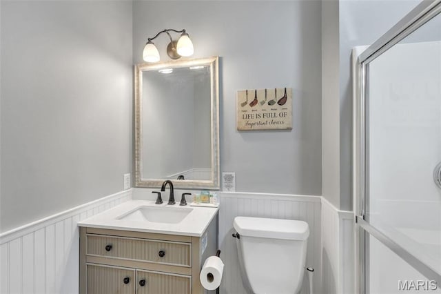 3560 Saint Albans Rd, Saint Albans, MO 63073 - bathroom featuring a wainscoted wall, vanity, toilet, and a decorative wall
