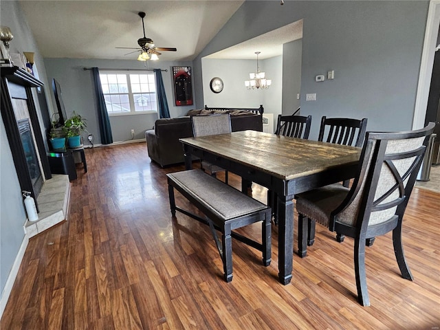 19782 Sugar Ln, Waynesville, MO 65583 - dining room featuring a ceiling fan, a chandelier, wood finished floors, lofted ceiling, and baseboards