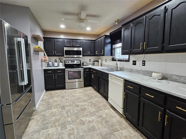 19782 Sugar Ln, Waynesville, MO 65583 - kitchen with appliances with stainless steel finishes, a sink, backsplash, ceiling fan, and recessed lighting
