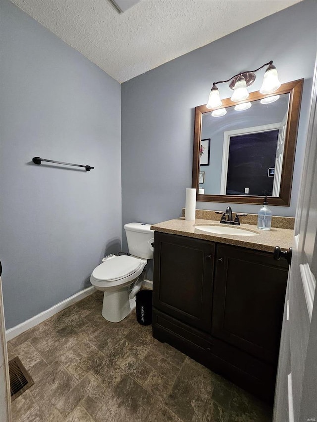 19782 Sugar Ln, Waynesville, MO 65583 - half bath with toilet, vanity, baseboards, a textured ceiling, and stone finish flooring