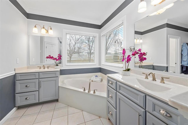 bathroom featuring two vanities, a bath, crown molding, and tile patterned flooring