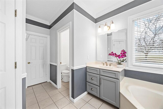 bathroom featuring tile patterned flooring, a garden tub, crown molding, toilet, and vanity