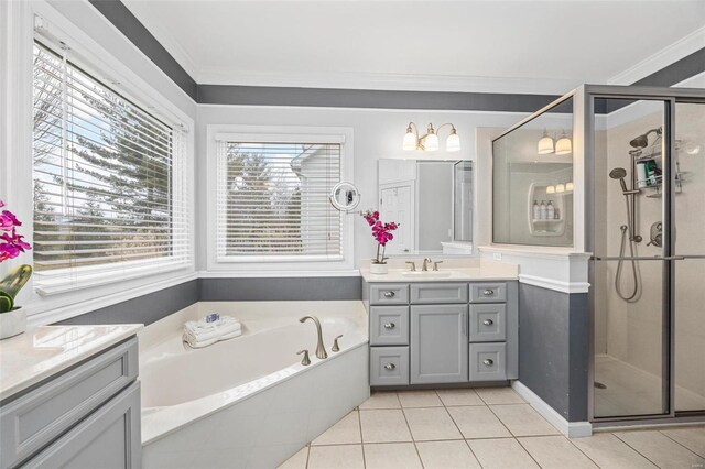 bathroom featuring tile patterned flooring, a shower stall, vanity, a bath, and crown molding