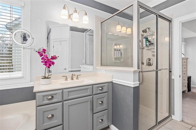 bathroom with a shower stall, vanity, and tile patterned flooring