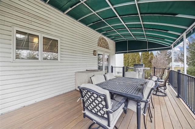 wooden deck with outdoor dining area and grilling area