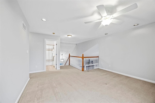 carpeted empty room featuring a ceiling fan, baseboards, and recessed lighting