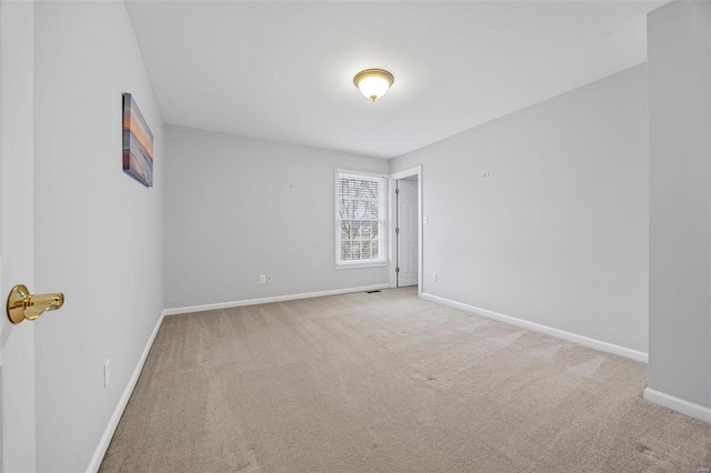 carpeted spare room with baseboards