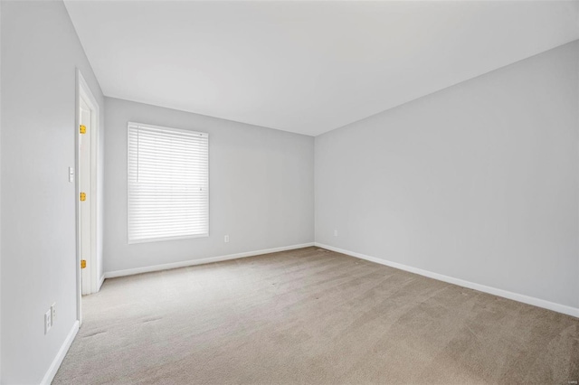 carpeted empty room with baseboards