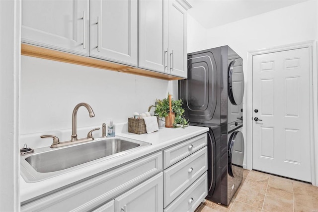 laundry room with stacked washer and clothes dryer and cabinet space