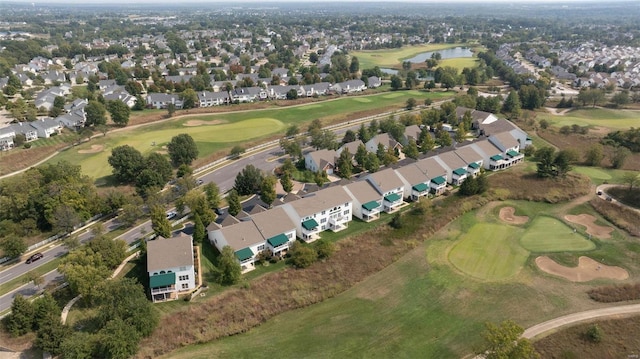 aerial overview of property's location with a local golf course, nearby suburban area, and a nearby body of water