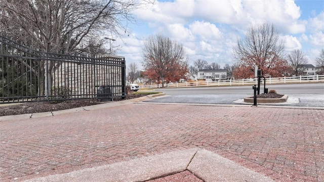 view of decorative road featuring curbs