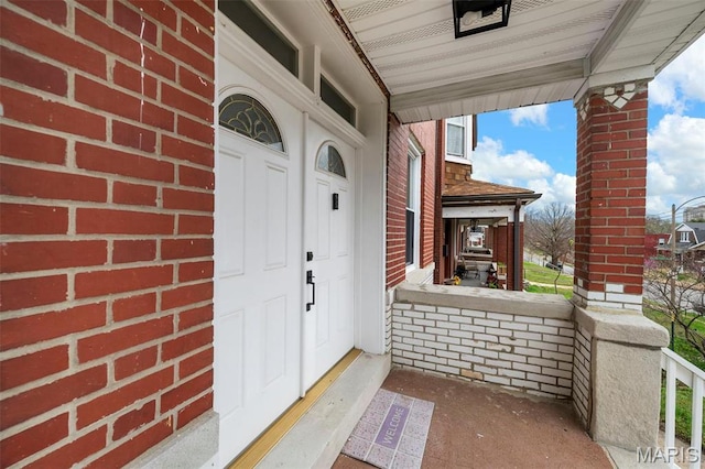 3801 Potomac St, Saint Louis, MO 63116 - doorway to property featuring a porch and brick siding
