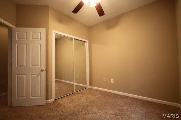 3801 Potomac St, Saint Louis, MO 63116 - unfurnished bedroom with carpet flooring, a closet, and ceiling fan