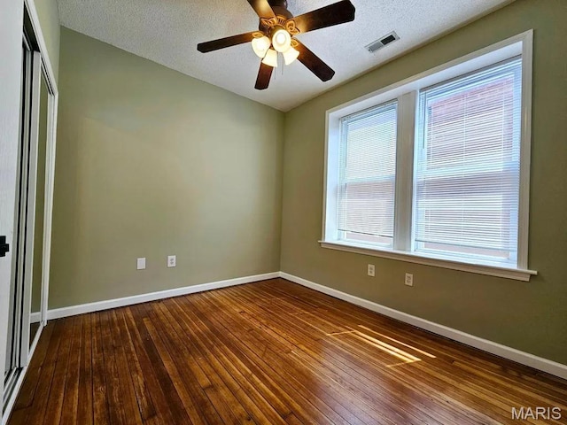 3801 Potomac St, Saint Louis, MO 63116 - spare room featuring wood-type flooring, ceiling fan, and a textured ceiling