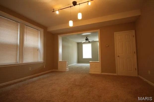 3801 Potomac St, Saint Louis, MO 63116 - carpeted empty room featuring baseboards and a ceiling fan