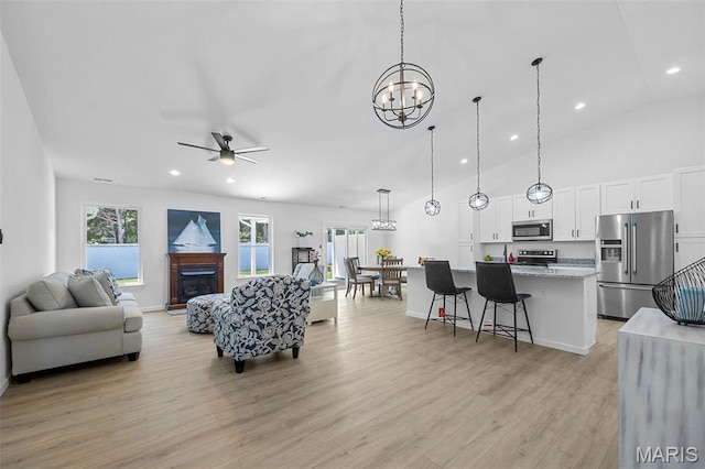 1569 Hickory Lndg, De Soto, MO 63020 - living area with a chandelier, light wood-type flooring, a fireplace, a ceiling fan, and recessed lighting
