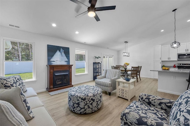 1569 Hickory Lndg, De Soto, MO 63020 - living area featuring light wood finished floors, ceiling fan, vaulted ceiling, baseboards, and recessed lighting