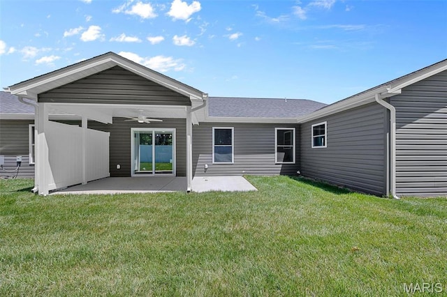 1569 Hickory Lndg, De Soto, MO 63020 - rear view of property featuring a ceiling fan, a patio area, a lawn, and a shingled roof