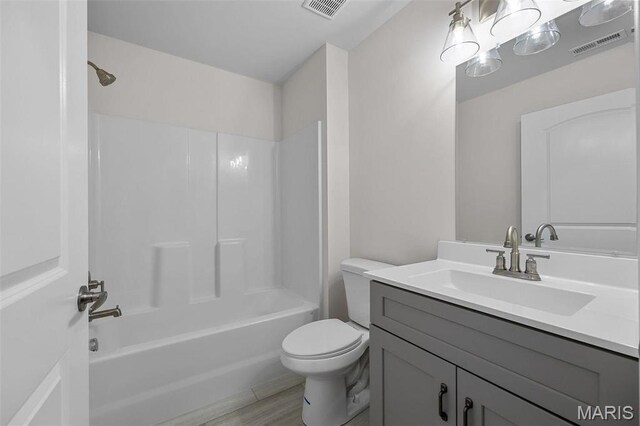 1569 Hickory Lndg, De Soto, MO 63020 - full bathroom featuring toilet, vanity, tub / shower combination, and wood finished floors