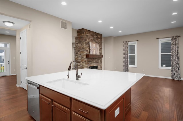 4036 Hempstead St, Saint Charles, MO 63301 - kitchen featuring a sink, dishwasher, dark wood-type flooring, open floor plan, and an island with sink