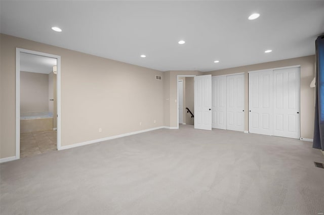 4036 Hempstead St, Saint Charles, MO 63301 - unfurnished bedroom featuring light colored carpet, multiple closets, recessed lighting, baseboards, and connected bathroom