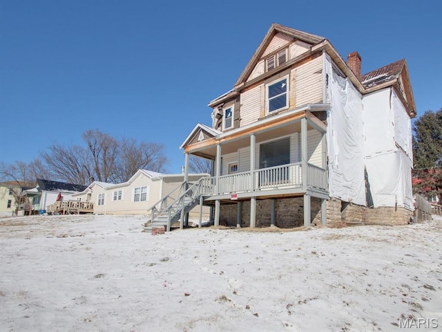 1700 Chestnut, Hannibal, MO 63401 - view of front of house featuring covered porch, a chimney, and stairs