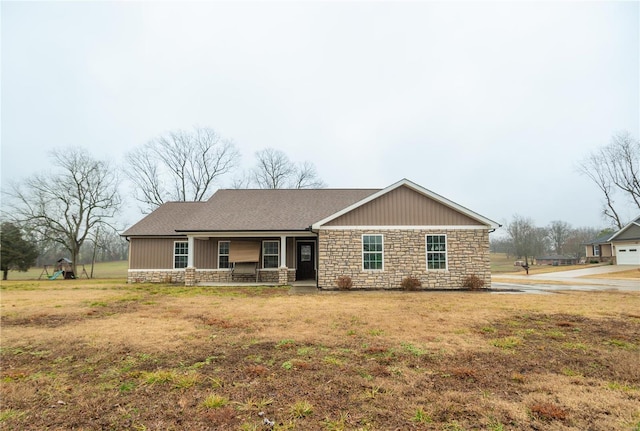 12 Paradise St, Benton, MO 63736 - single story home with stone siding, a porch, a front yard, and a garage
