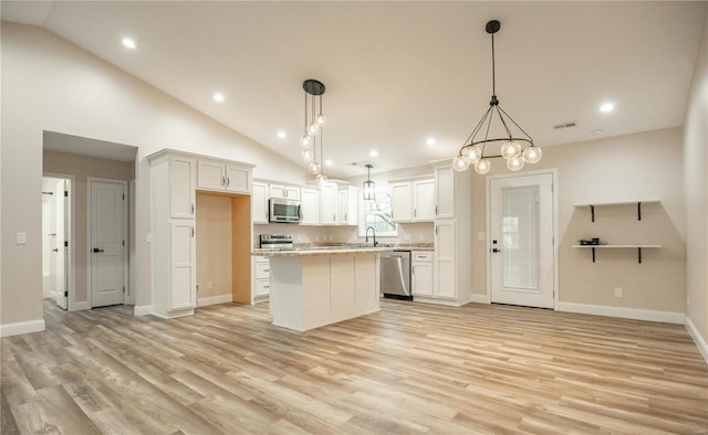 12 Paradise St, Benton, MO 63736 - kitchen with stainless steel appliances, lofted ceiling, a center island, light wood-style floors, and baseboards