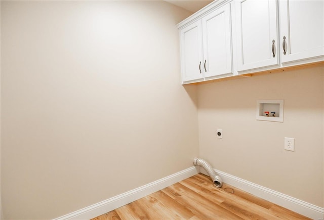 12 Paradise St, Benton, MO 63736 - laundry area featuring hookup for an electric dryer, cabinet space, baseboards, light wood-style flooring, and hookup for a washing machine
