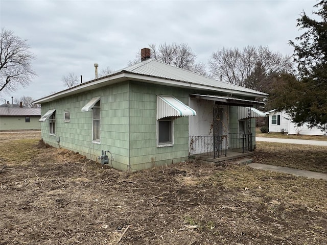 1000 White St, Canton, MO 63435 - view of side of home featuring a chimney and metal roof