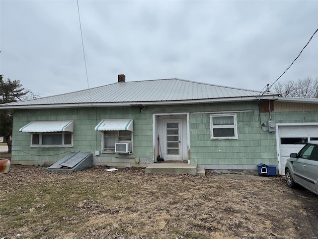 1000 White St, Canton, MO 63435 - rear view of property with metal roof, cooling unit, and an attached garage