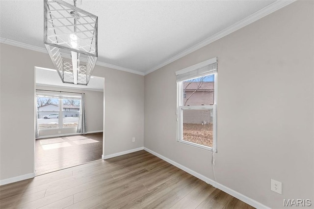 655 Lakewood Dr, Lake St Louis, MO 63367 - spare room featuring wood finished floors, healthy amount of natural light, crown molding, and baseboards