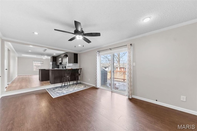 655 Lakewood Dr, Lake St Louis, MO 63367 - unfurnished living room with ceiling fan, wood finished floors, baseboards, crown molding, and a textured ceiling