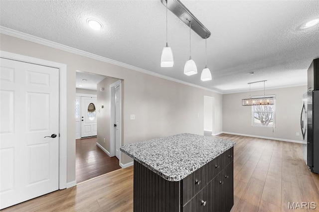 655 Lakewood Dr, Lake St Louis, MO 63367 - kitchen with a textured ceiling, wood finished floors, baseboards, crown molding, and a kitchen island