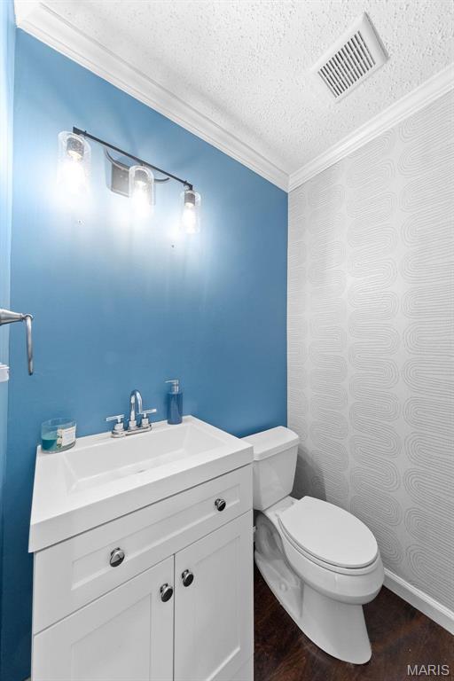 655 Lakewood Dr, Lake St Louis, MO 63367 - bathroom with a textured ceiling, ornamental molding, toilet, wood finished floors, and vanity