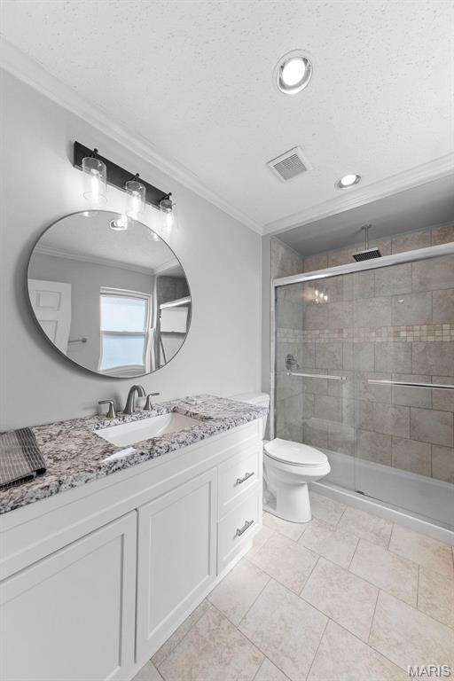655 Lakewood Dr, Lake St Louis, MO 63367 - full bathroom with ornamental molding, vanity, a stall shower, toilet, and a textured ceiling
