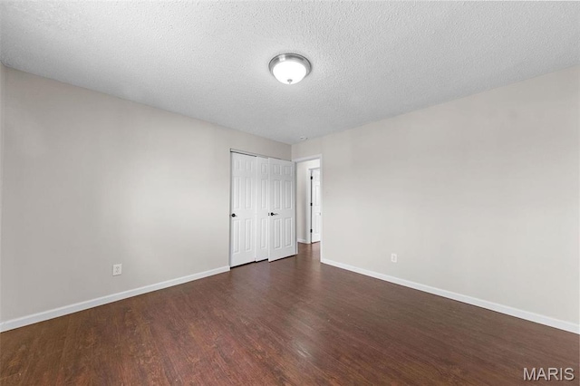 655 Lakewood Dr, Lake St Louis, MO 63367 - unfurnished room with wood finished floors, baseboards, and a textured ceiling